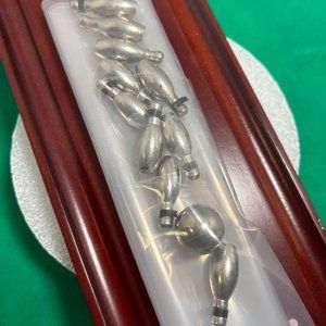 Desktop bowling game. Includes 10 metal pins and ball. 12" x 3-3/4".  (470)